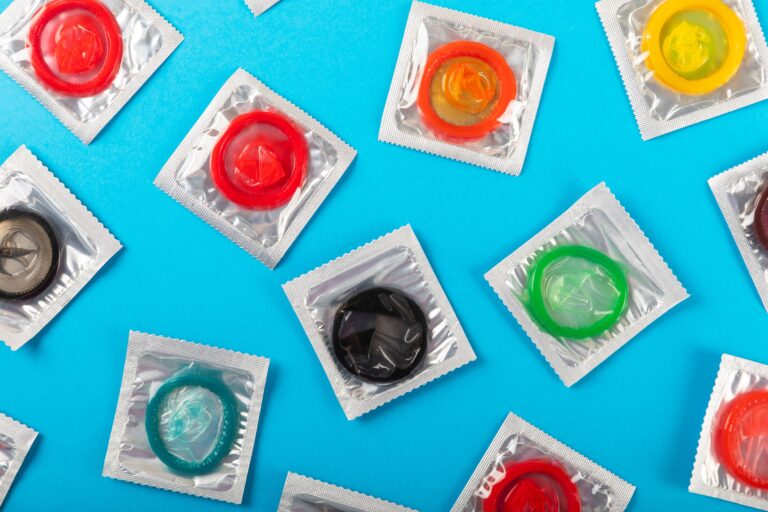 Condoms,Of,Bright,Colors,On,A,Blue,Background.,Flatley.pattern.the,Concept
